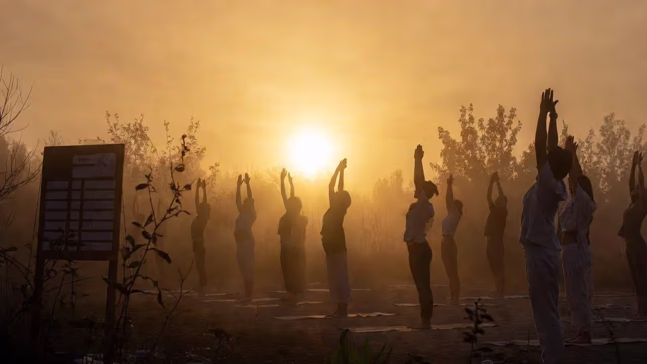 Morning yoga session at sunrise during a structured retreat schedule.