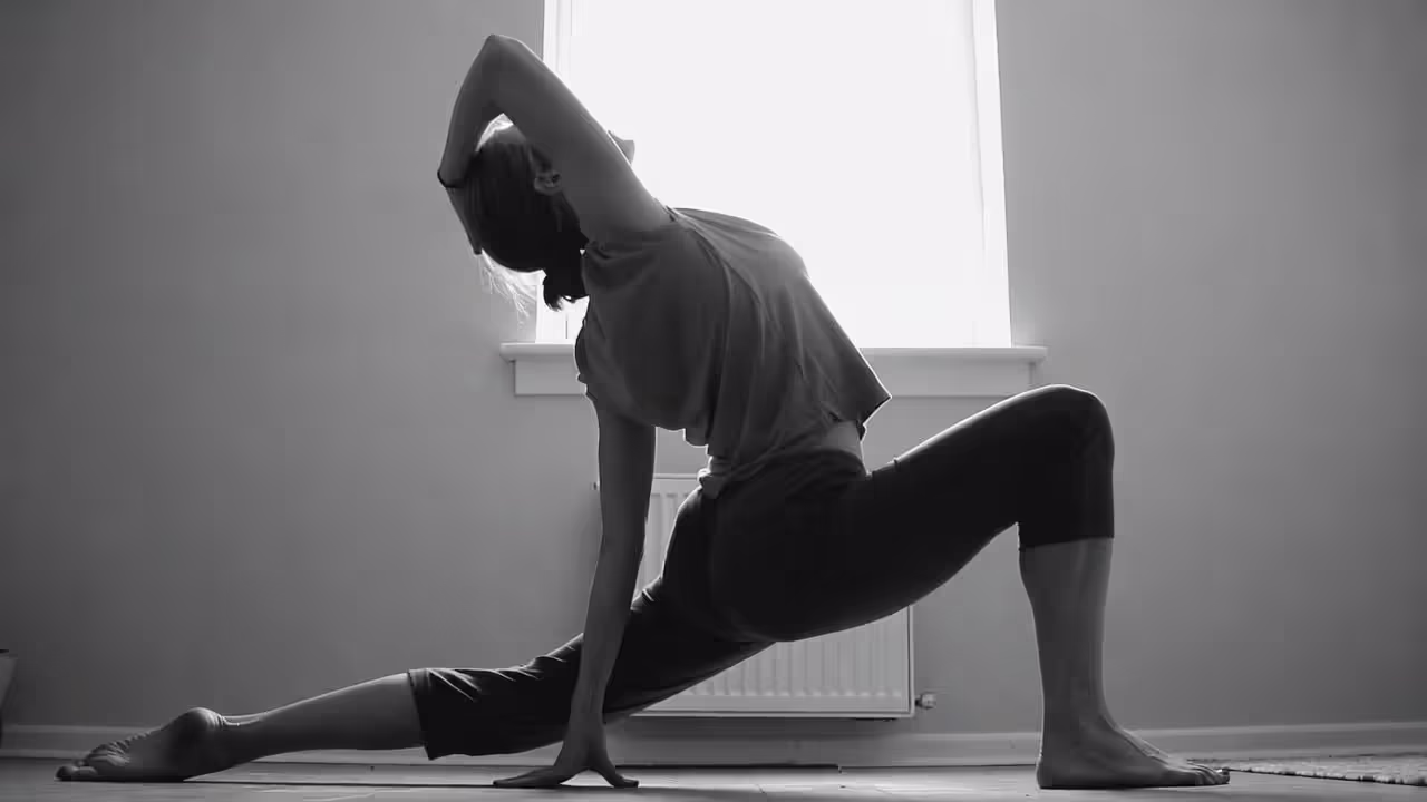 Person combining a short yoga practice with reflective note-taking from therapy.